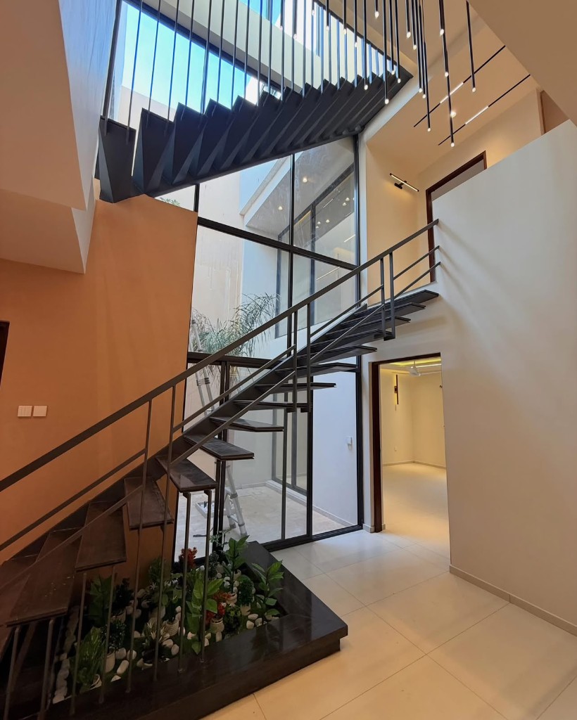 Villa Terra foyer with terracotta accent wall and indoor planting